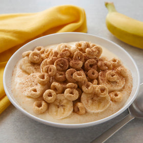 Set of Cheerios Honey Nut cups and box rests neatly on the counter.