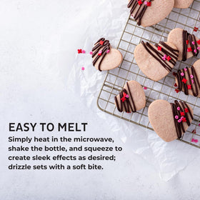 Chefmaster chocolate drizzle over strawberries for a shiny dessert finish.