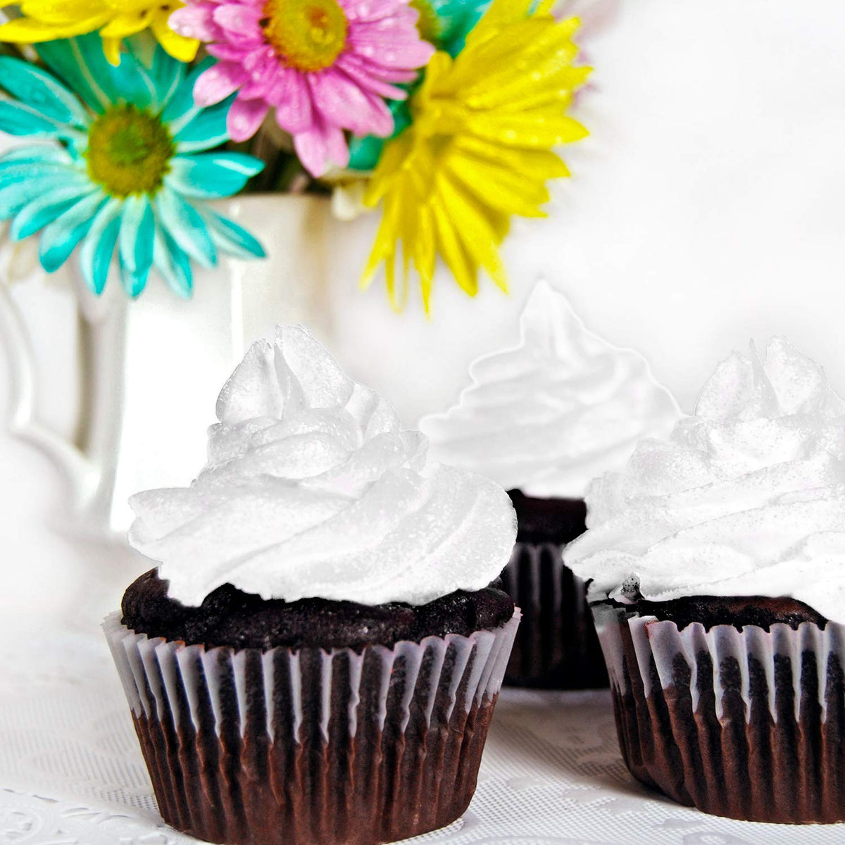Chefmaster white edible color mist used for smooth cake detailing.
