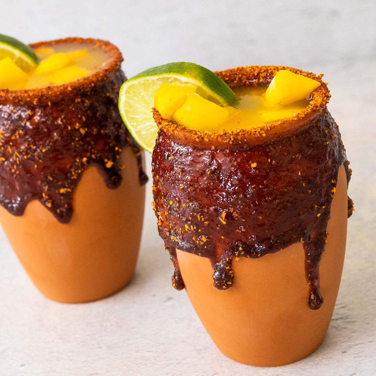 Cheilitas Chamoy Mango Rim Dip being poured for drinks