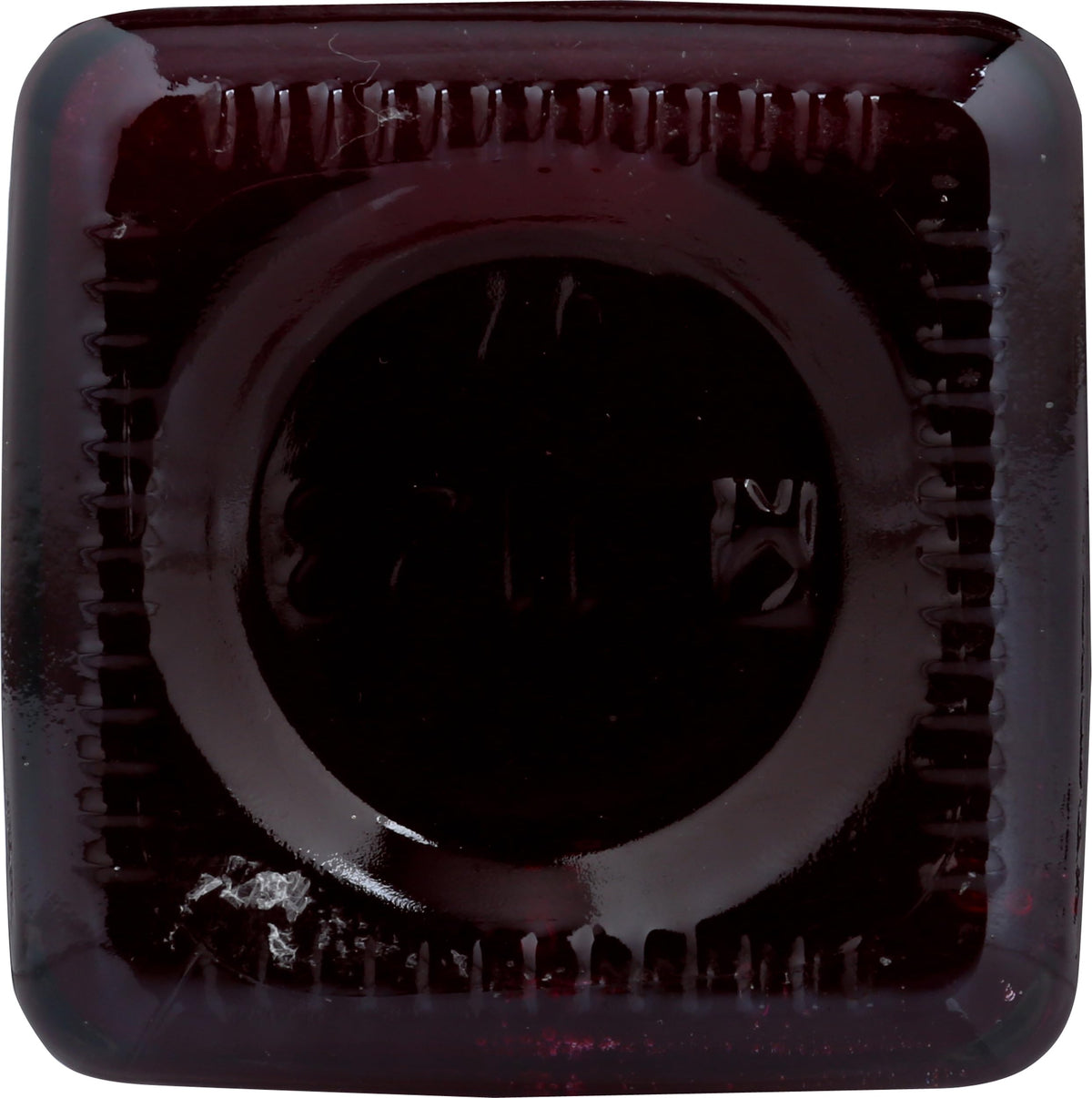 Cheri's Desert Harvest Prickly Pear Syrup magenta glass highlighting vibrant color.