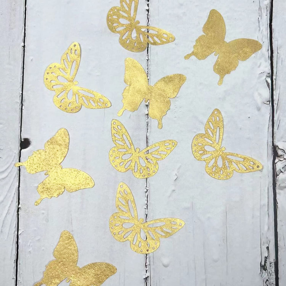 CHOCKACAKE gold butterflies attached with icing on cakes