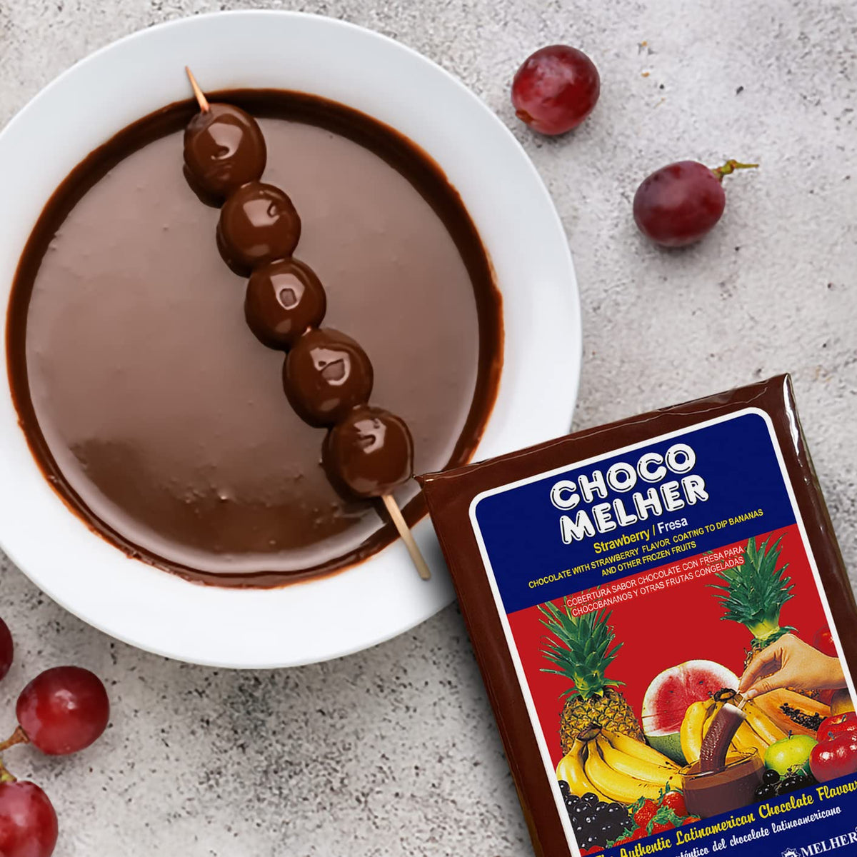 Chocomelher coating splash on a chocolate-dipped fruit.
