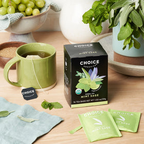 Choice Organic Teas Mint Sage Tea mint leaves over a cup create a soothing moment.