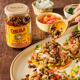 Pizza finished with Cholula Chili Crisp adds heat and texture.