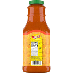 Pouring Cholula Chili Garlic Hot Sauce for controlled spice addition.