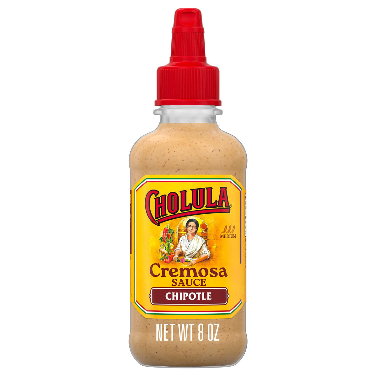 Cholula Chipotle Cremosa bottle drizzling onto tacos for smoky creaminess.