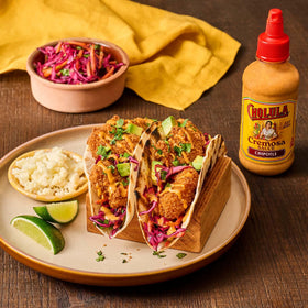 Cholula Chipotle Cremosa squeeze bottle ready to drizzle on bowls.