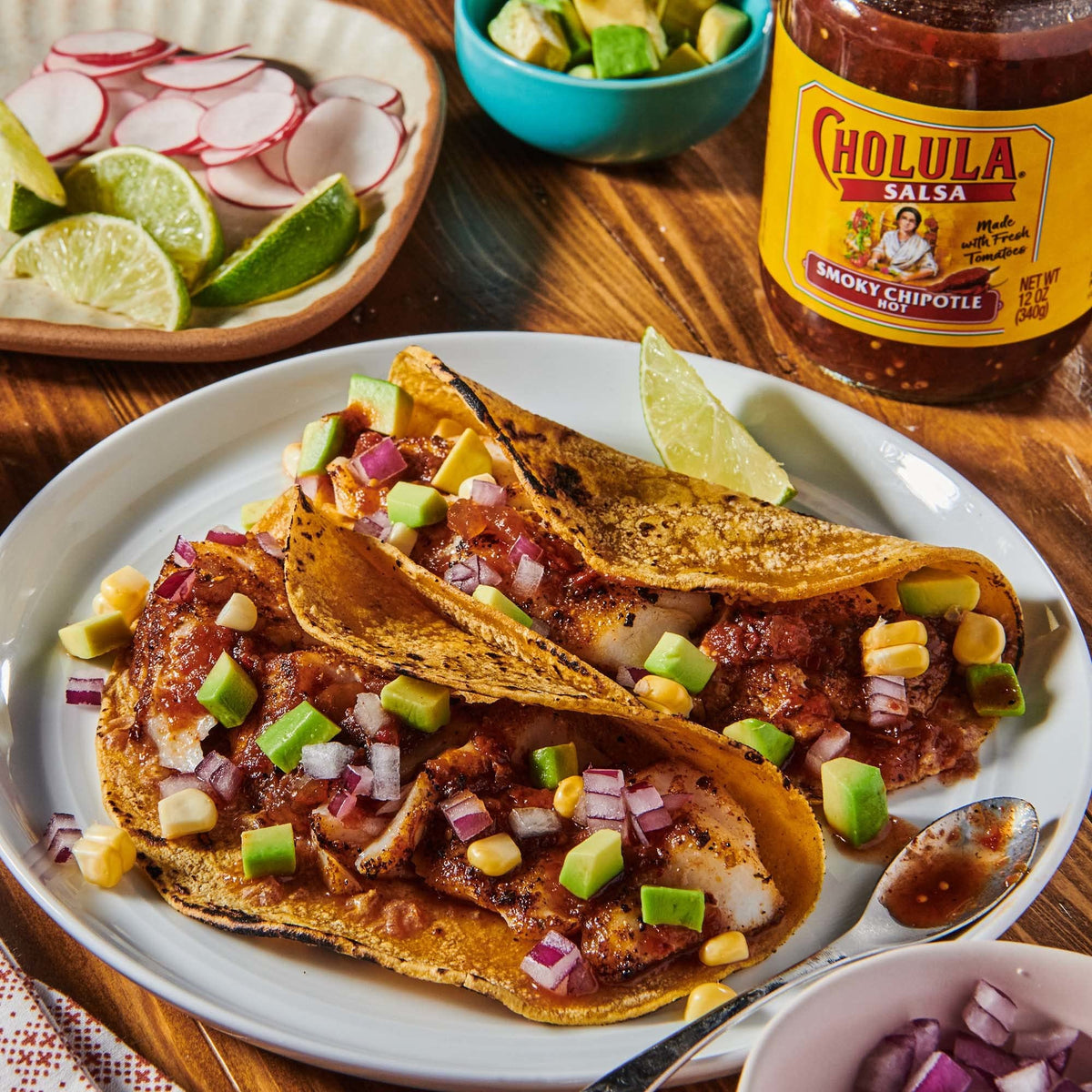Cholula Smoky Chipotle Salsa jar on a table ready to serve with chips.