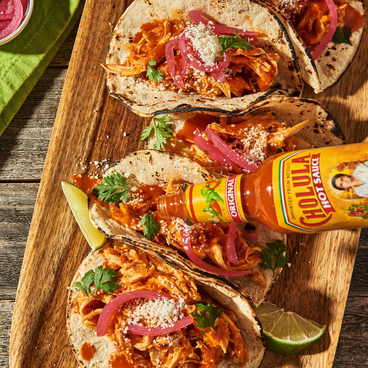Cholula Sweet Habanero Hot Sauce bottle next to margarita and salsa