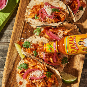 Cholula Sweet Habanero Hot Sauce bottle next to margarita and salsa