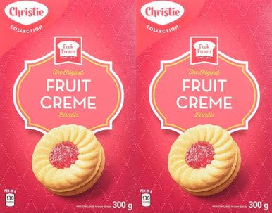 Christie Peek Freans Fruit Creme cookies beside a mug, perfect tea time companion.