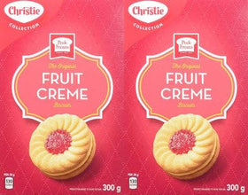 Christie Peek Freans Fruit Creme cookies beside a mug, perfect tea time companion.