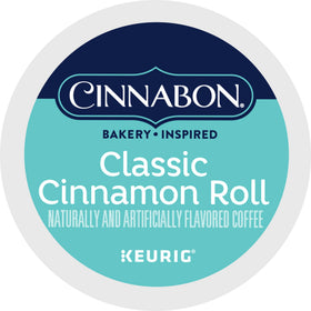 Lifestyle shot of CINNABON box, mug, and cinnamon ambiance.