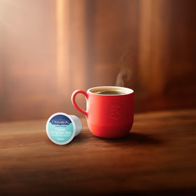 CINNABON single-serve coffee on a tidy desk for a break.