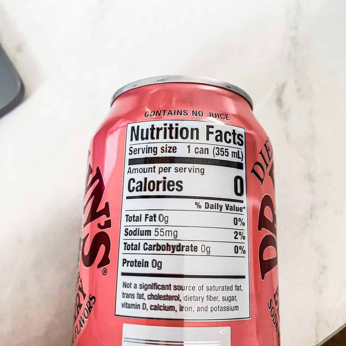 Circle of Drink Dr Brown's Diet Black Cherry Soda label close-up emphasizes natural flavors.
