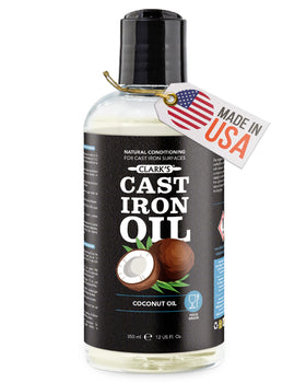 CLARK'S Cast Iron Oil bottle pouring for rust-preventing seasoning.
