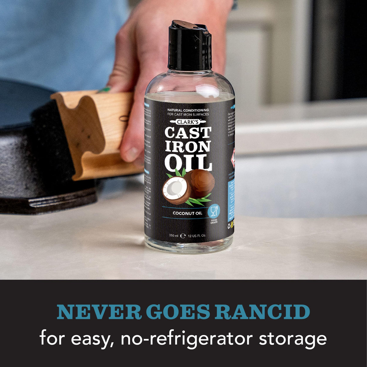 CLARK'S Cast Iron Oil bottle with wooden spoon spreading on cookware.