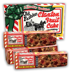 Claxton Fruit Cake Dark Recipe 3-Pack carton on holiday table, ideal for gifting.