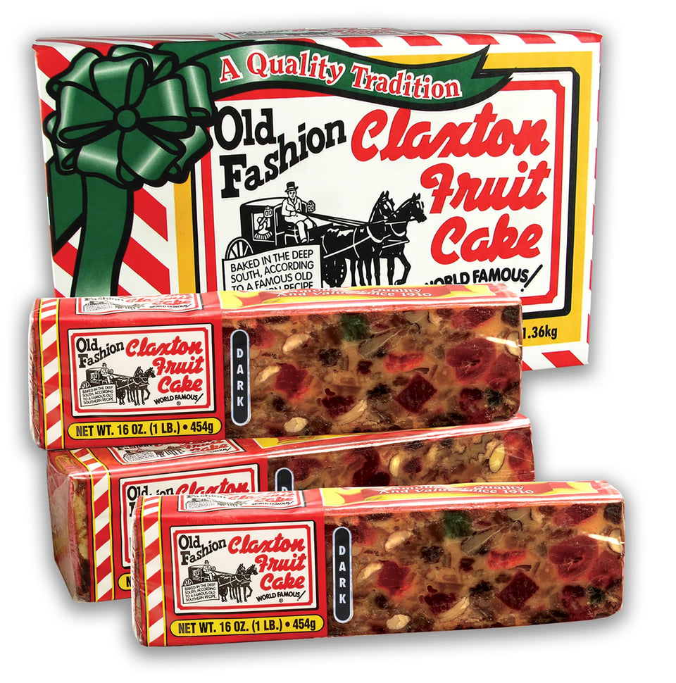 Claxton Fruit Cake Dark Recipe 3-Pack carton on holiday table, ideal for gifting.