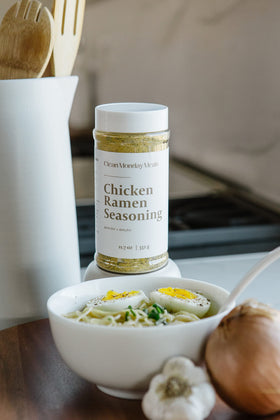 Ramen bowl with steaming broth featuring Clean Monday Meals seasoning.
