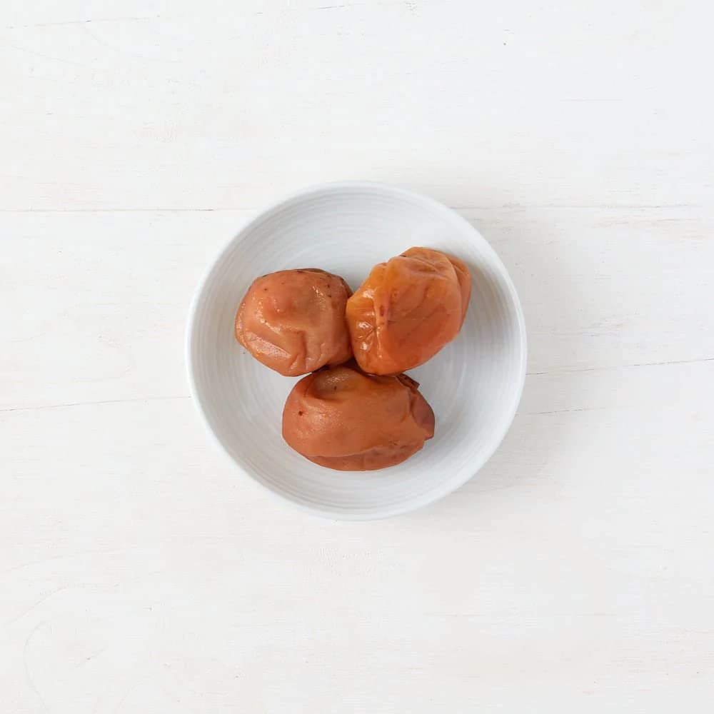 Clearspring umeboshi close-up highlights vibrant color for zesty salad finish.