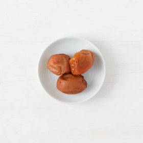 Clearspring umeboshi close-up highlights vibrant color for zesty salad finish.