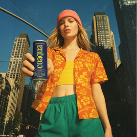 CoAqua Sparkling Coconut Water can-in-hand conveys portable refreshment after workouts.