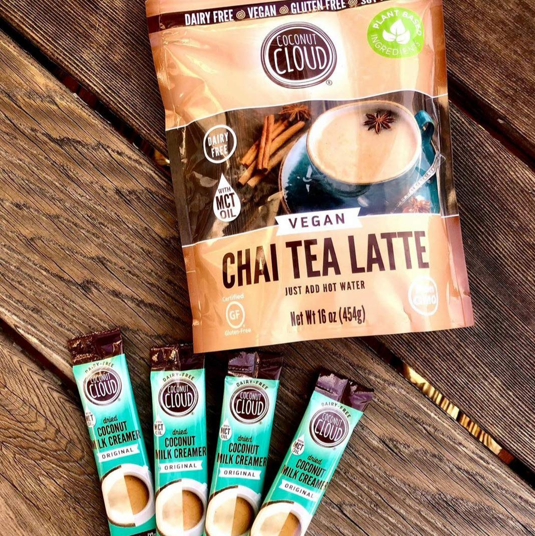 Pouring Coconut Cloud into hot coffee for a creamy, dairy-free texture.