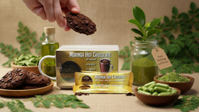 CocoRinga Moringa Hot Chocolate scoop-powder beside moringa leaves signals natural ingredients