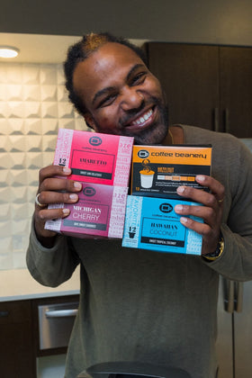 Box of Coffee Beanery Amaretto single-serve pods displayed in a cozy kitchen