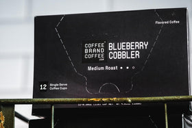 Coffee Brand Coffee Blueberry Cobbler K-Cups pack label detail with holiday-inspired design.