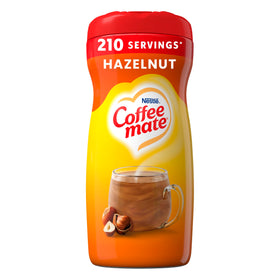 Coffee-mate Hazelnut powdered creamer being poured into a cup for a silky, nutty boost