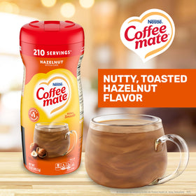Coffee Mate Hazelnut scoop in coffee cup for quick, rich flavor.