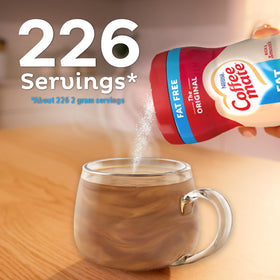 Coffee Mate creamer packets beside a steaming mug for morning ritual