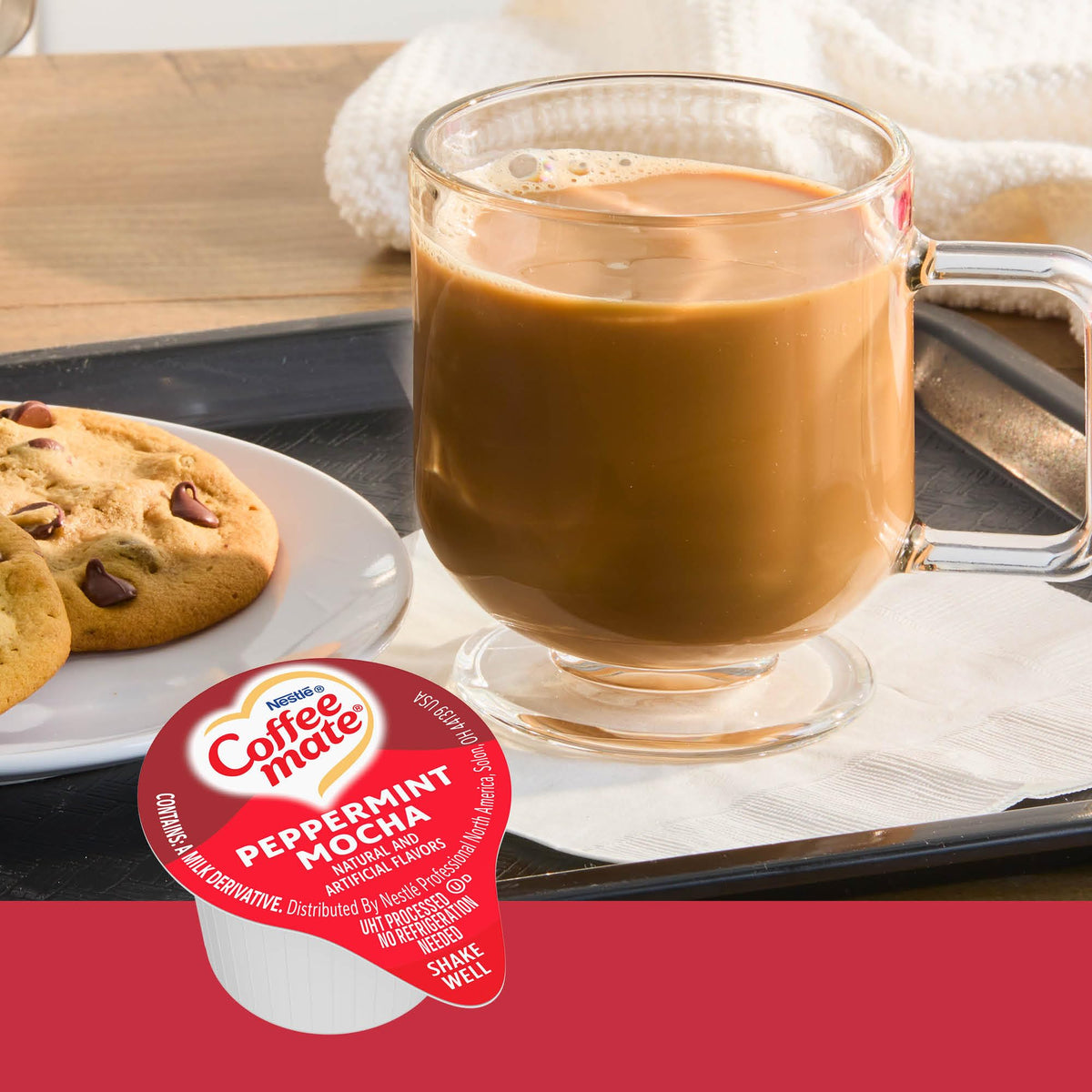 Coffee mate Peppermint Mocha creamer poured into a hot cup of coffee for rich flavor.