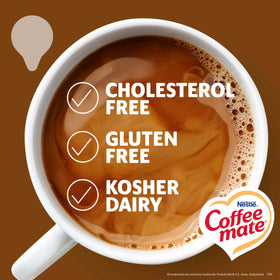 Coffee Mate Snickers creamer being poured into a mug for a rich treat.
