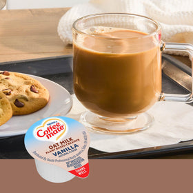 Coffee Mate vanilla oat milk creamer tub close-up highlighting on-the-go packaging
