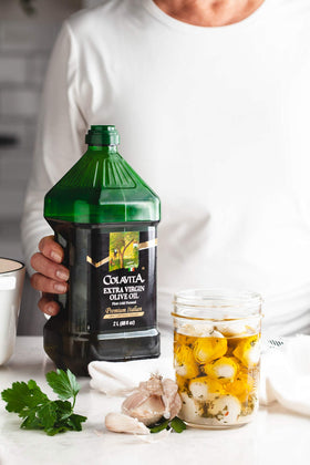 Colavita EVOO glass pour action invites drizzle on dishes.