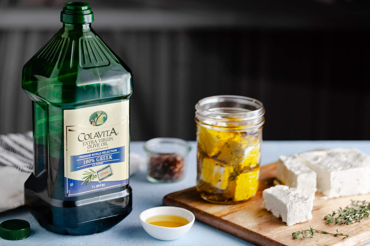 Colavita 2-liter jug showing Koroneiki and Kalamata olives blend for everyday cooking.