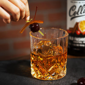 Collins mix being poured into a glass for a balanced base