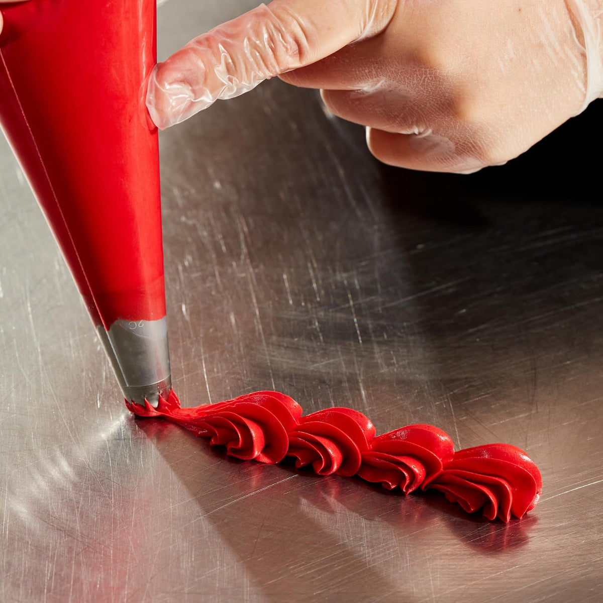 Colour Mill red oil-based color coats ganache for a rich finish.