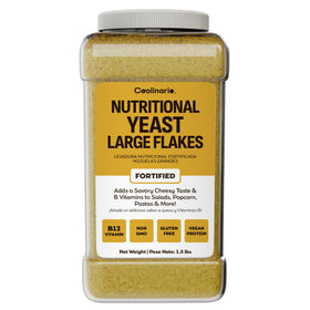 Coolinario nutritional yeast flakes bottle pour highlights savory flavor for vegan cooking and toppings.