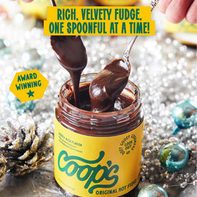 Coop's Hot Fudge on brownies creating a glossy, indulgent glaze.