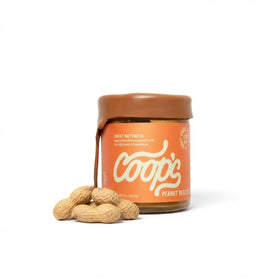 Coop's Peanut Butter Sauce jar close-up with creamy drizzle for desserts