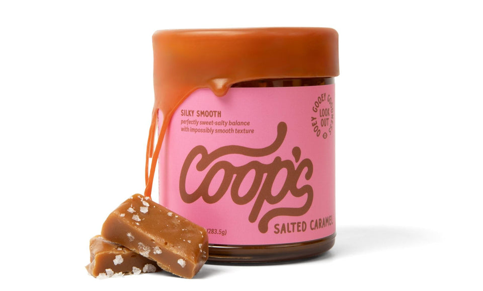 Coop's Salted Caramel Sauce bottle pours over dessert for rich flavor.