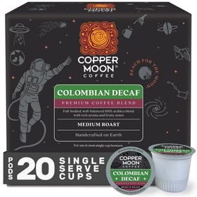 Copper Moon decaf K-Cup pods beside a mug for a smooth, convenient brew.