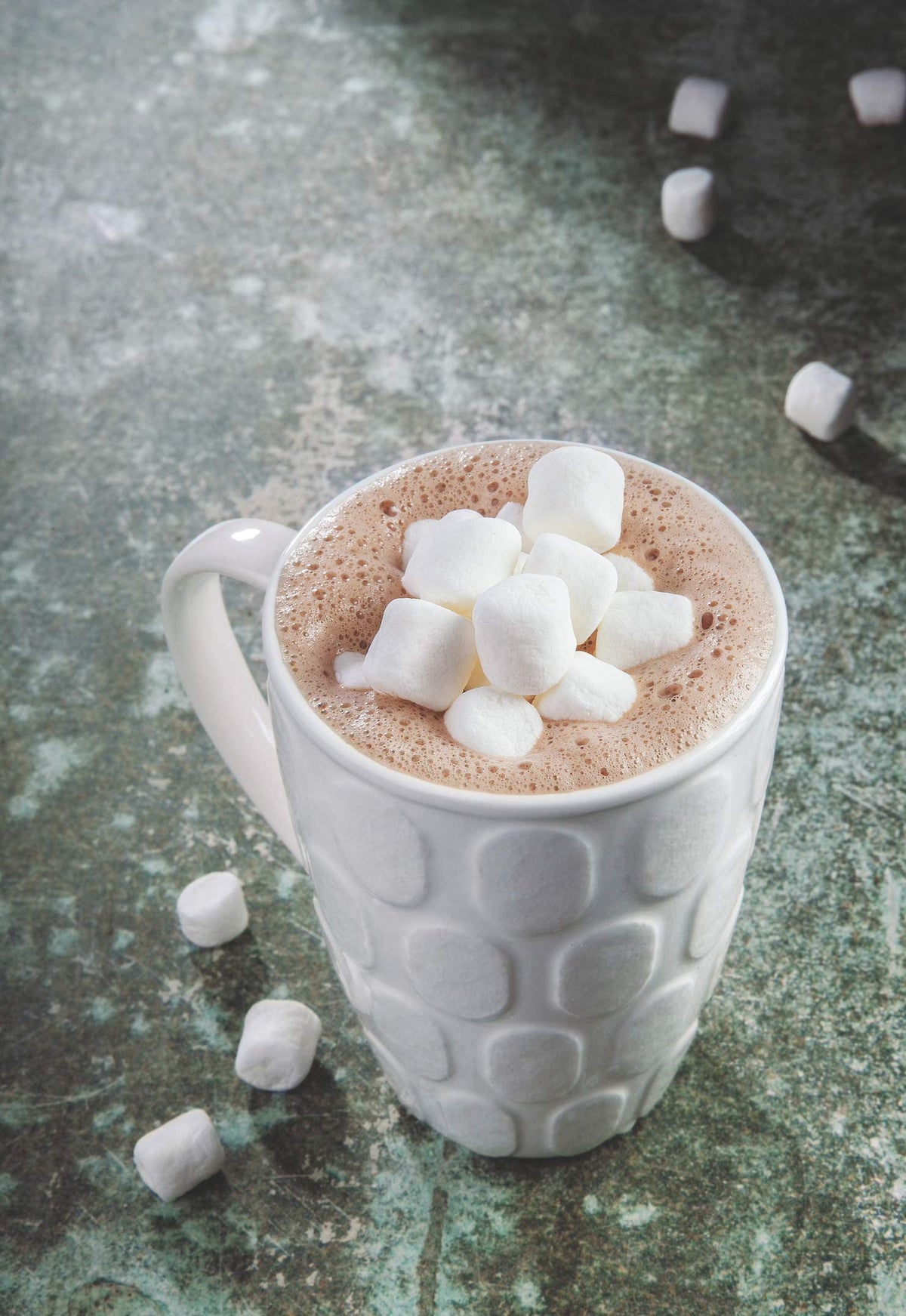 CORONA tablet dissolving in warm milk for a quick, comforting cup.