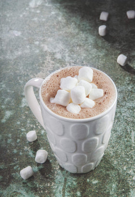 CORONA tablet dissolving in warm milk for a quick, comforting cup.