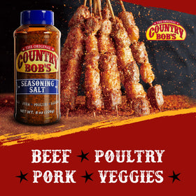 Country Bob's Seasoning Salt on kitchen counter beside vegetables for dinner prep.